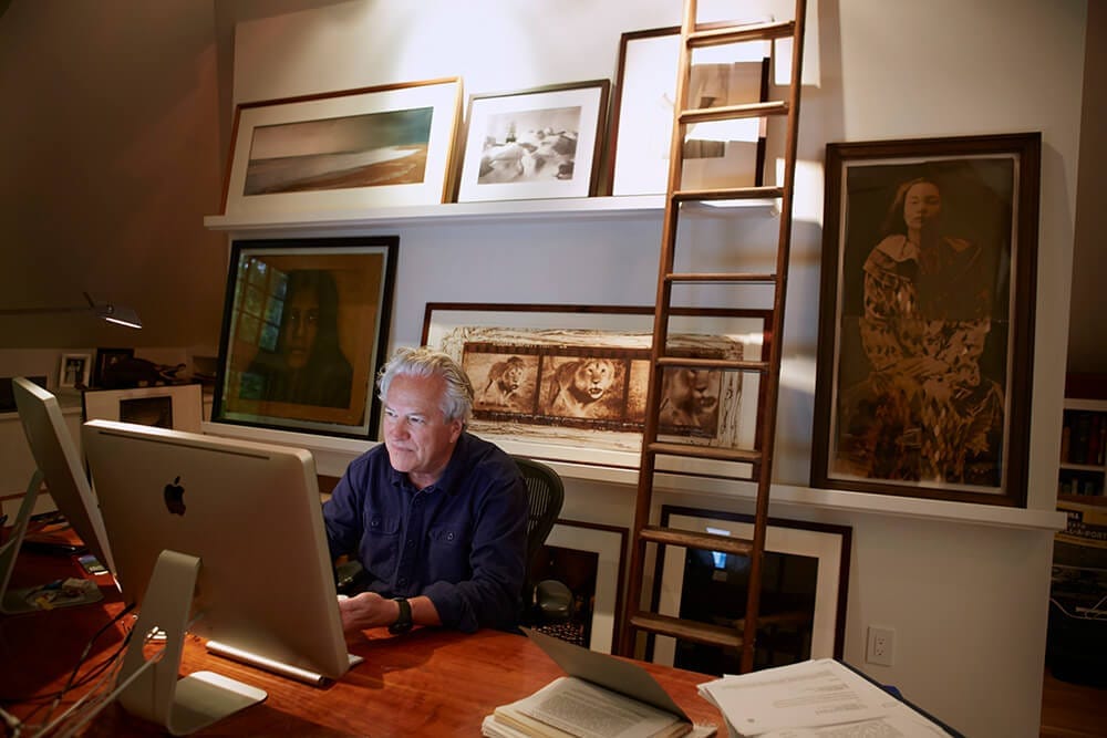 Jon Bowermaster at work surrounded by art