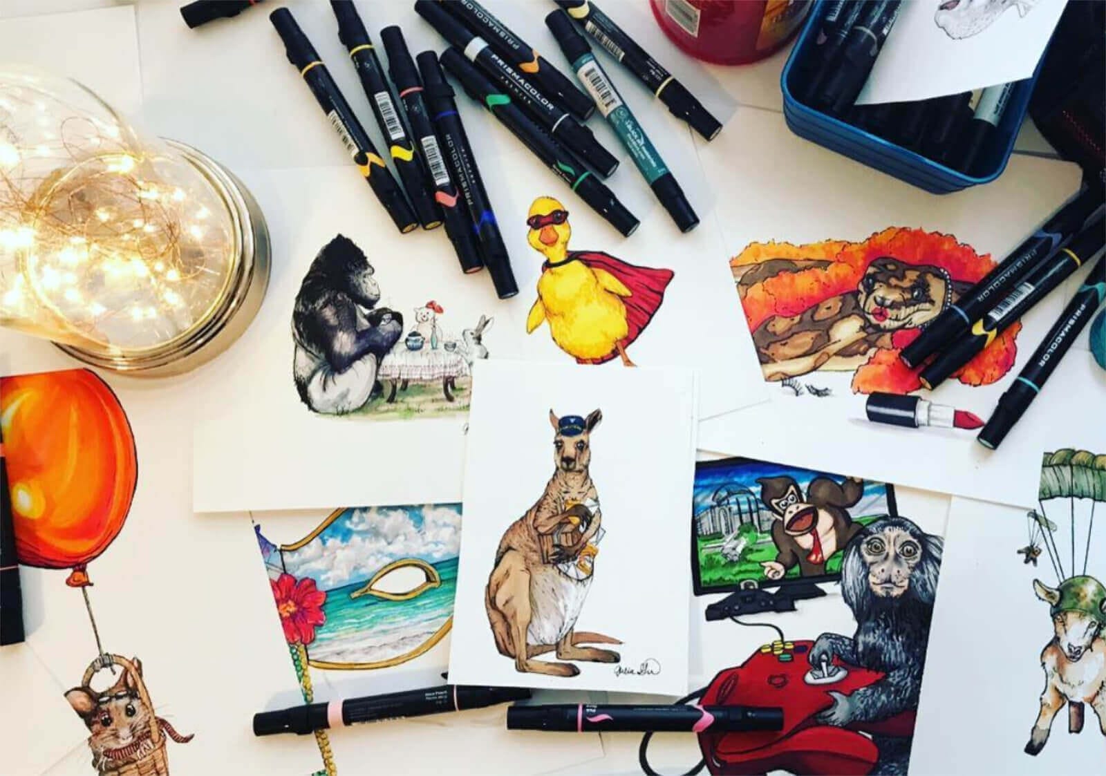 Julia Green's desk with art supplies and illustrations