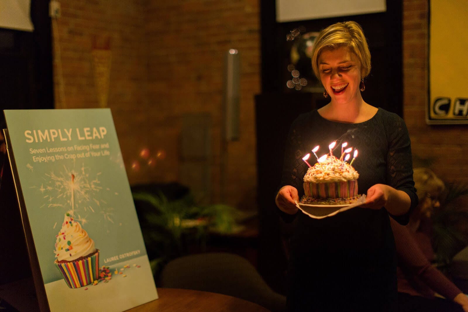 Lauree Ostrofsky holding a cake