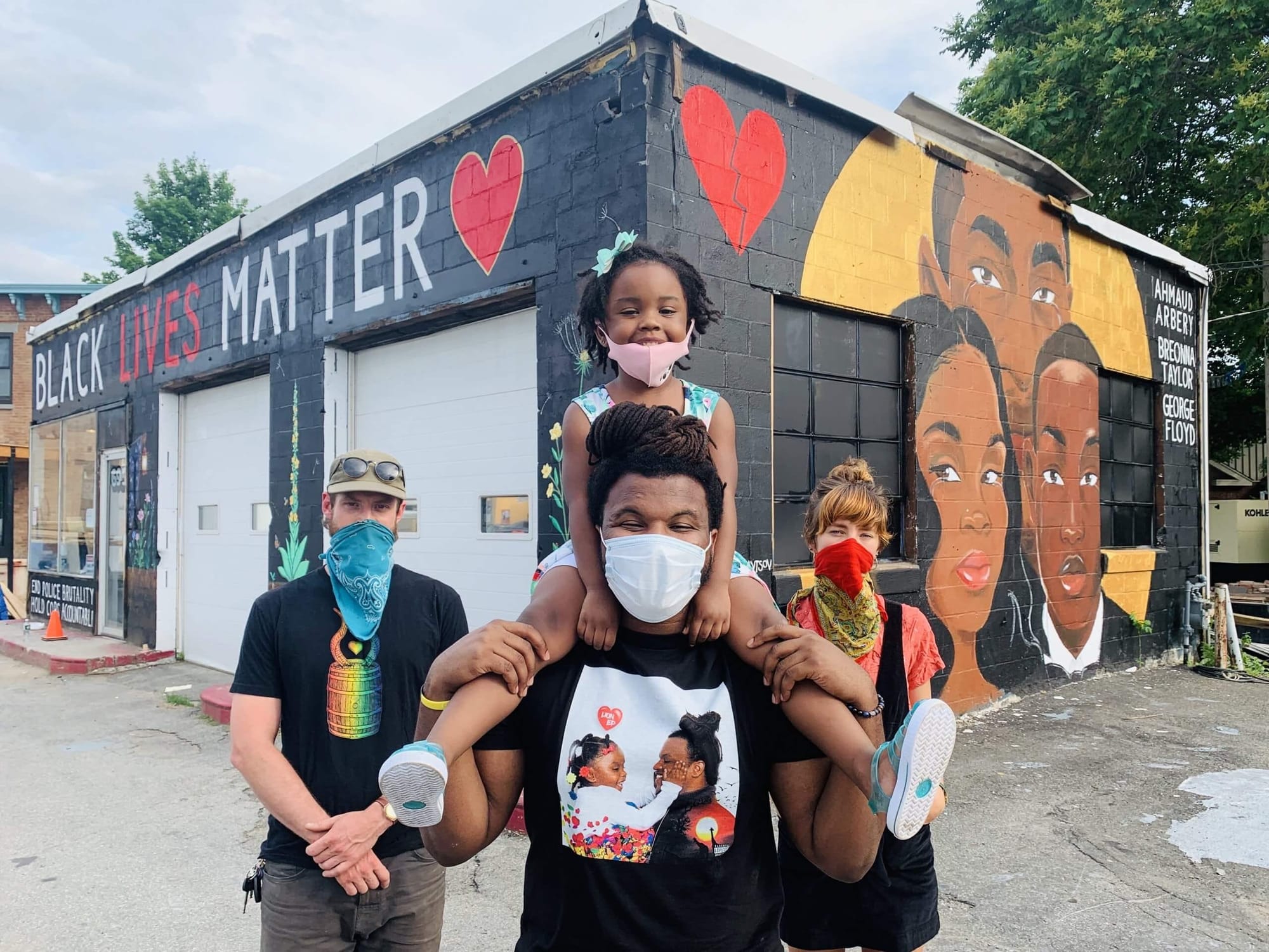 Jalani Lion in front of his Black Lives Matter mural