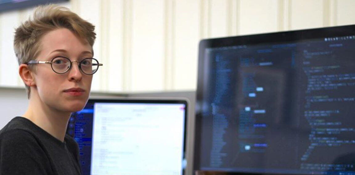 Milo Axelrod at their desk at Moonfarmer, writing code